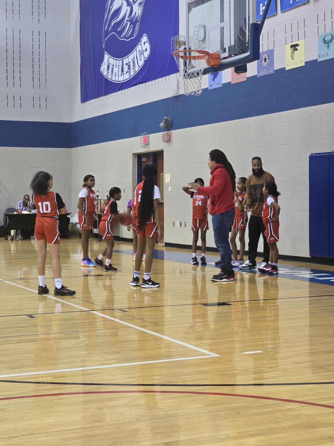 Coach Livers coaching a girls youth basketball team during a game