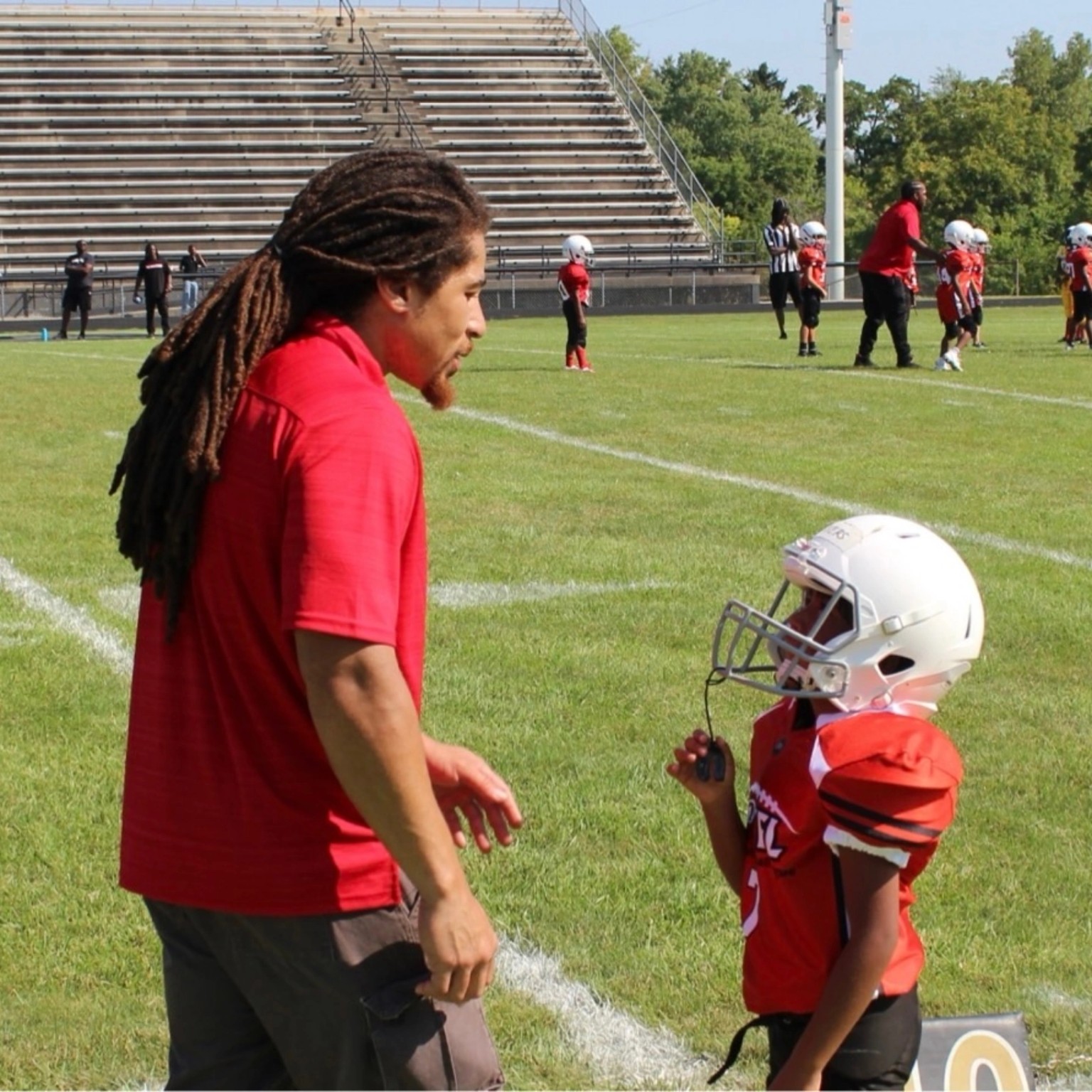 Coach Livers giving instruction during a youth football game