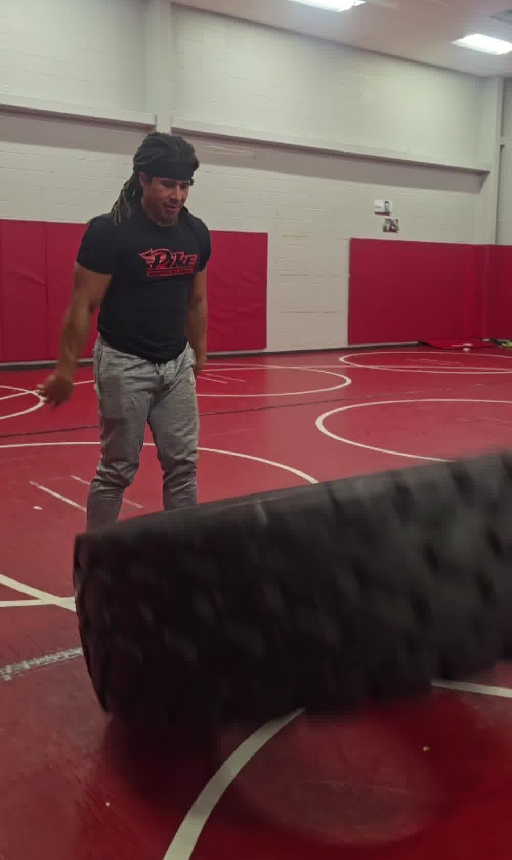 Coach Livers flipping a tire during youth wrestling conditioning